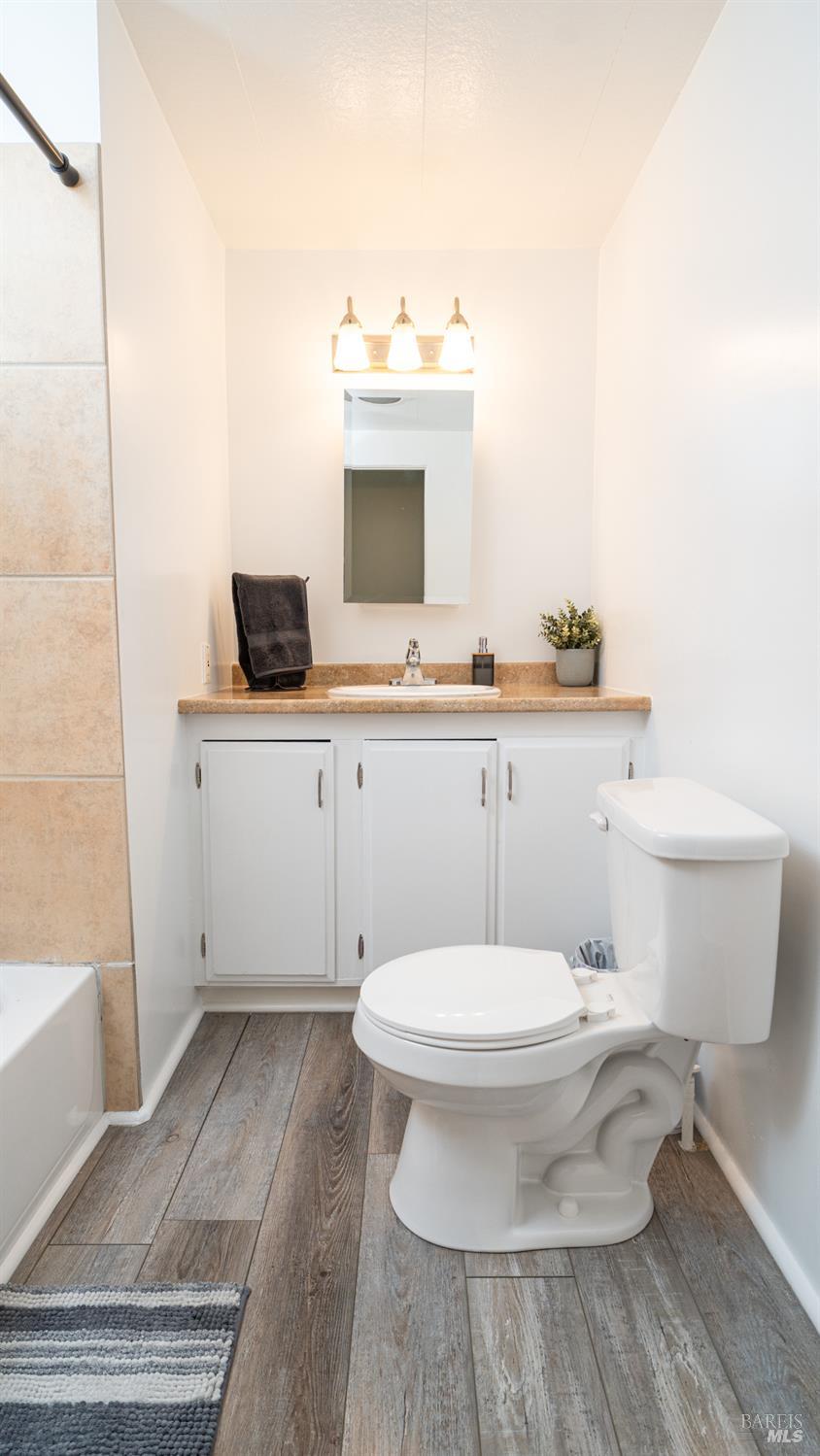 401 Frisbie Avenue Santa Rosa, CA 95407 - Photo 28 of 50 a bathroom with a toilet a sink and a mirror