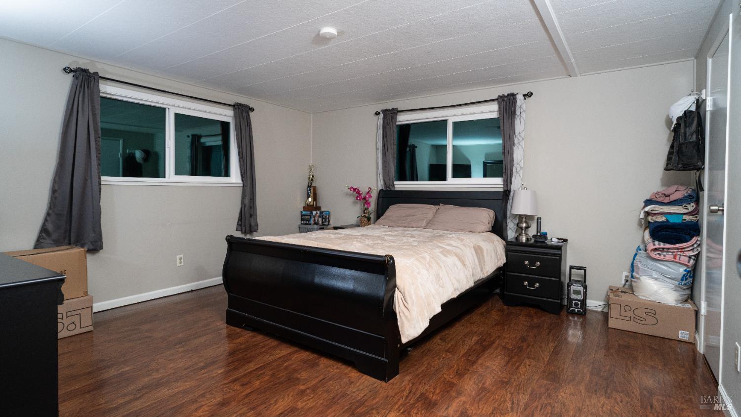 401 Frisbie Avenue Santa Rosa, CA 95407 - Photo 32 of 50 a bedroom with a bed and wooden floor