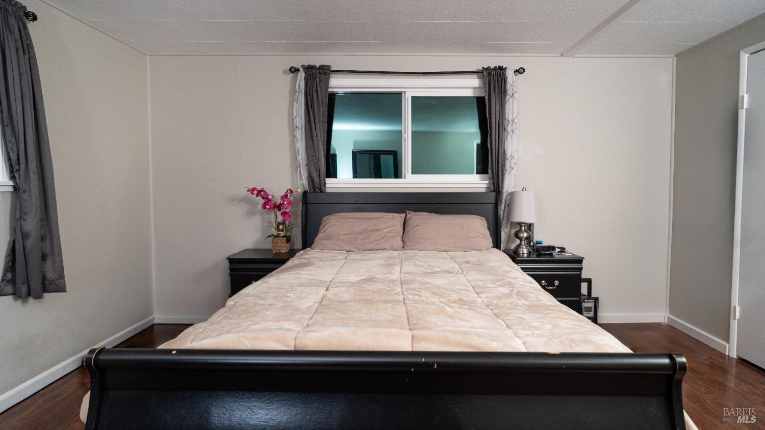 401 Frisbie Avenue Santa Rosa, CA 95407 - Photo 33 of 50 a bed sitting in a bedroom next to a window