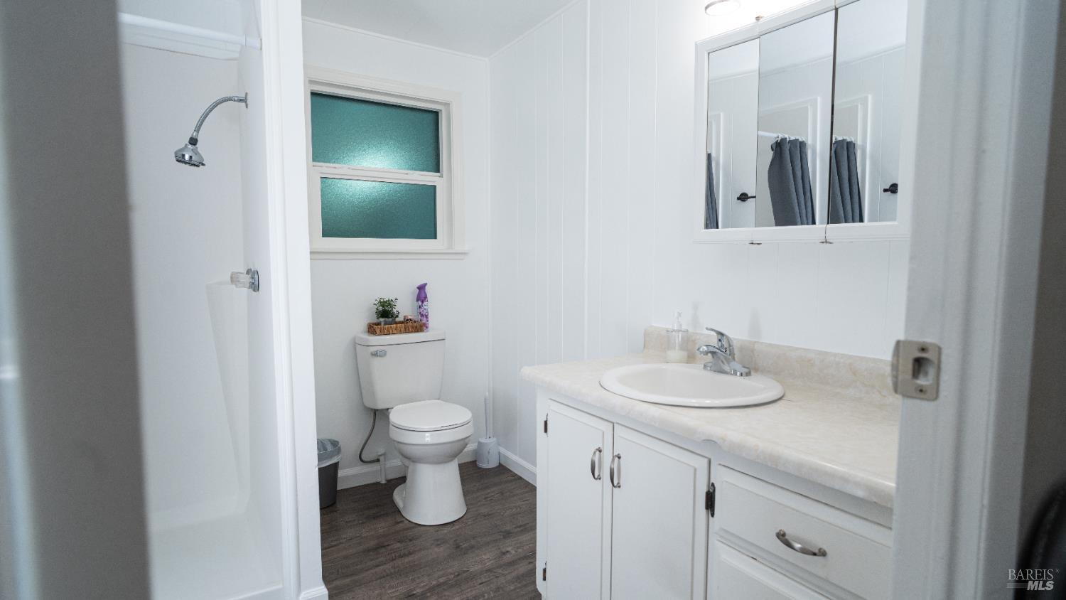 401 Frisbie Avenue Santa Rosa, CA 95407 - Photo 35 of 50 a bathroom with a toilet sink and mirror