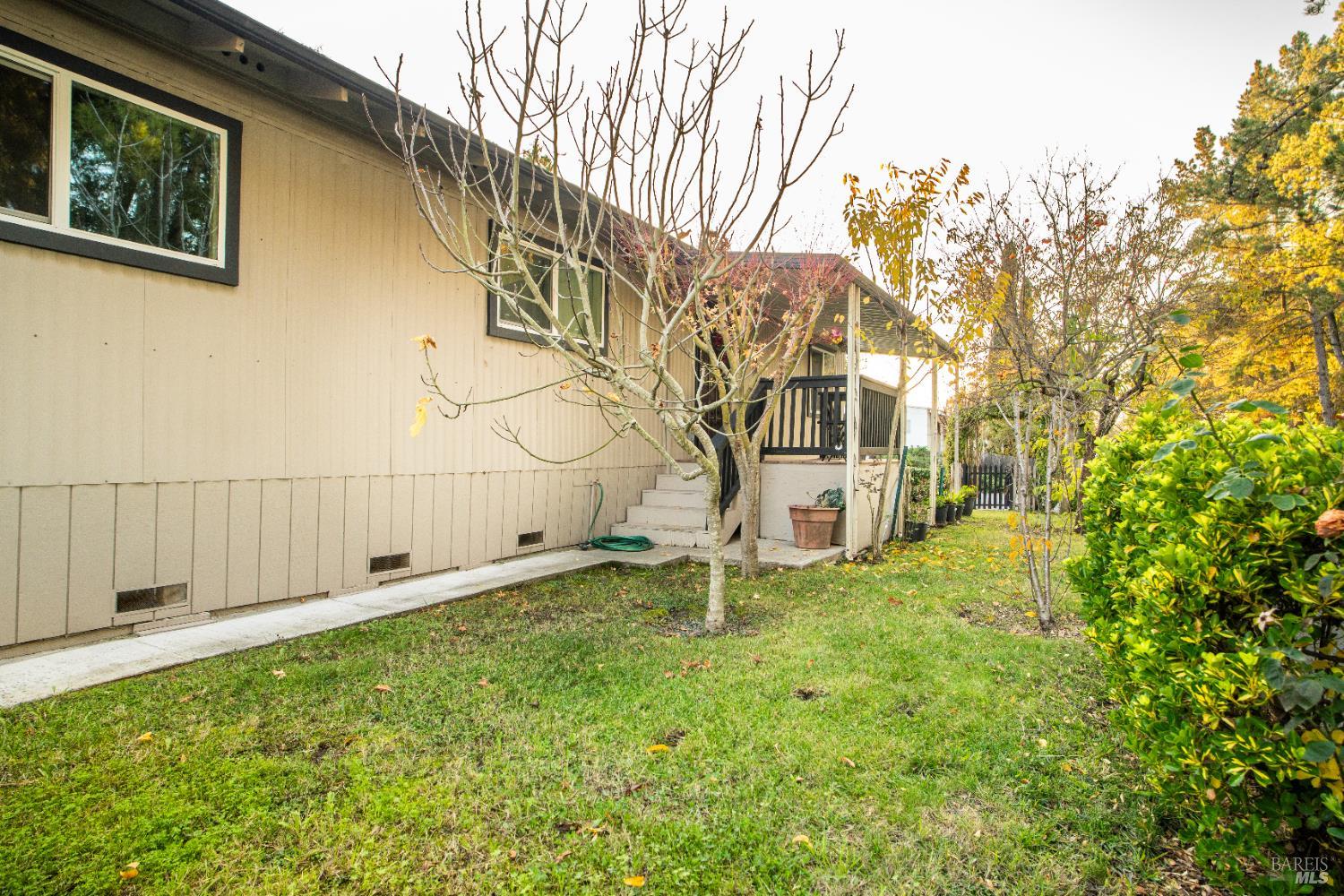 401 Frisbie Avenue Santa Rosa, CA 95407 - Photo 9 of 50 a backyard of a house with table and chairs