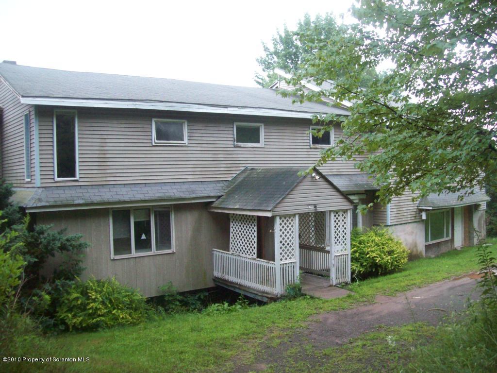 1 Rr Factoryville, PA 18419 - Photo 1 of 10 a front view of a house with a garden and yard