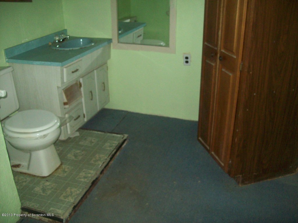 1 Rr Factoryville, PA 18419 - Photo 7 of 10 a bathroom with a granite countertop sink a toilet and with shower