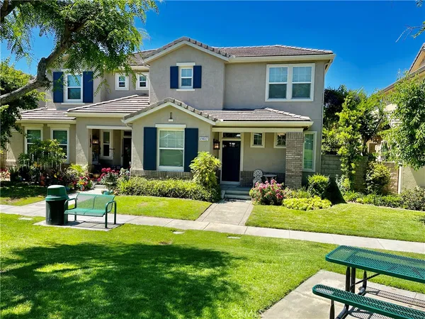 a front view of a house with a yard table and chairs