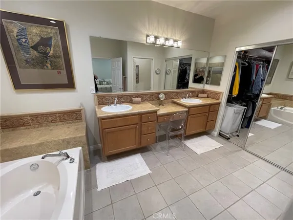 a spacious bathroom with a double vanity sink and a mirror