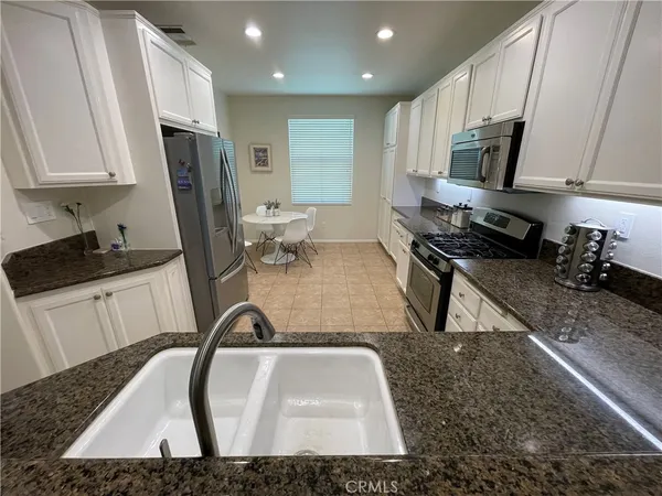 a kitchen with a sink a stove and a refrigerator