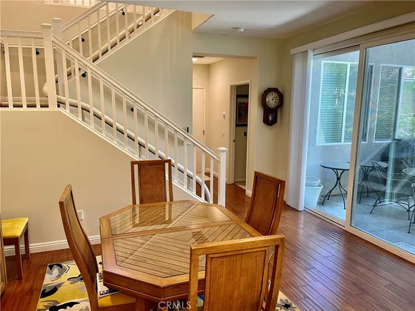 a dining room with furniture and wooden floor