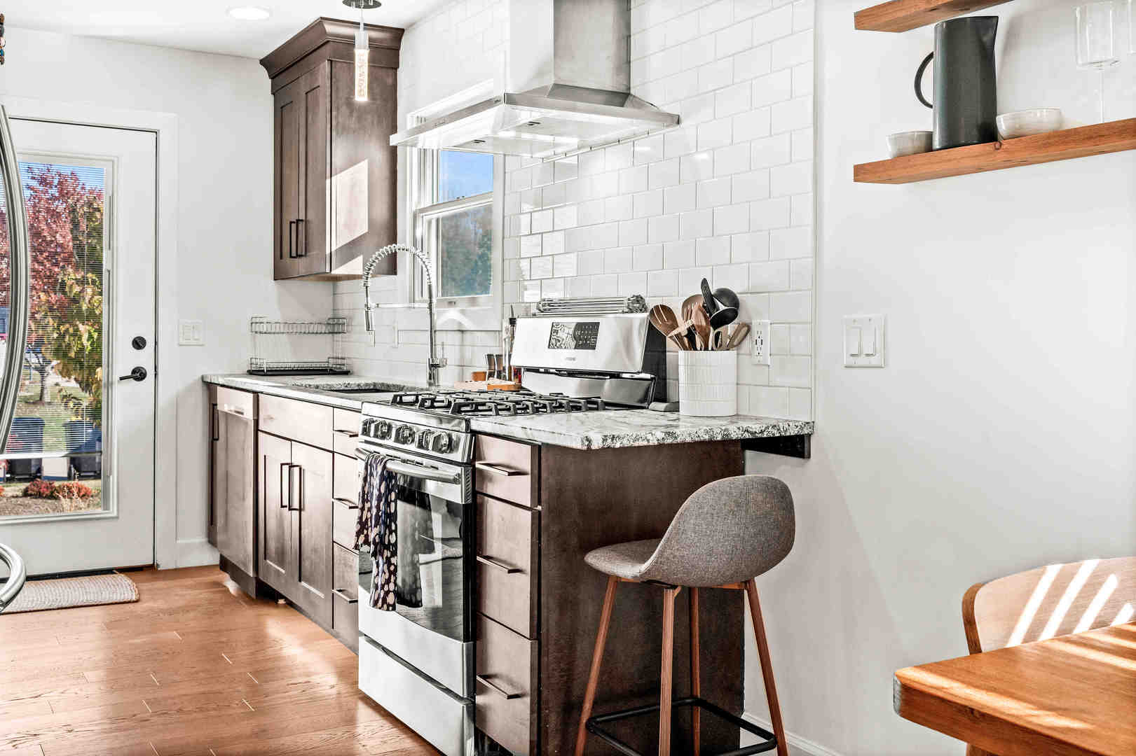 1402 River Landing Street Normal, IL 61761 - Photo 16 of 36 a kitchen with stainless steel appliances granite countertop a stove and a chair