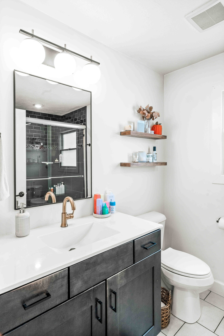 1402 River Landing Street Normal, IL 61761 - Photo 20 of 36 a bathroom with a sink a toilet and a mirror