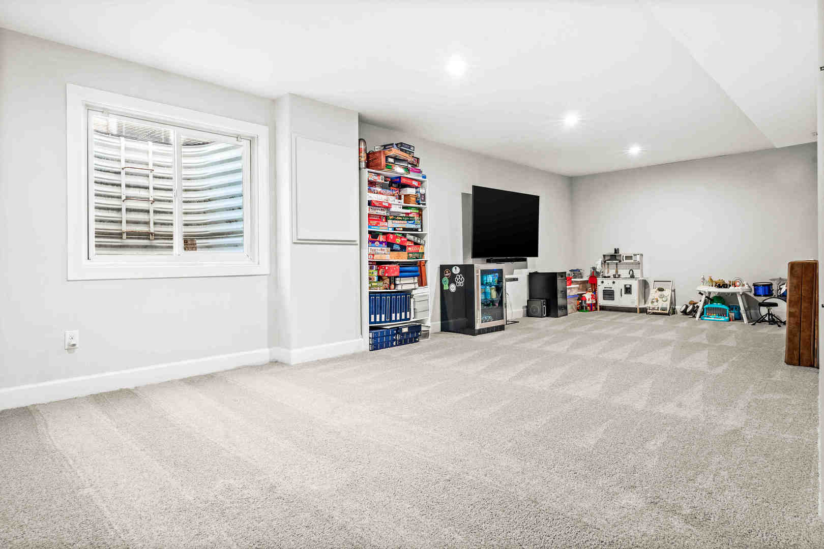 1402 River Landing Street Normal, IL 61761 - Photo 24 of 36 an empty room with furniture and a flat screen tv