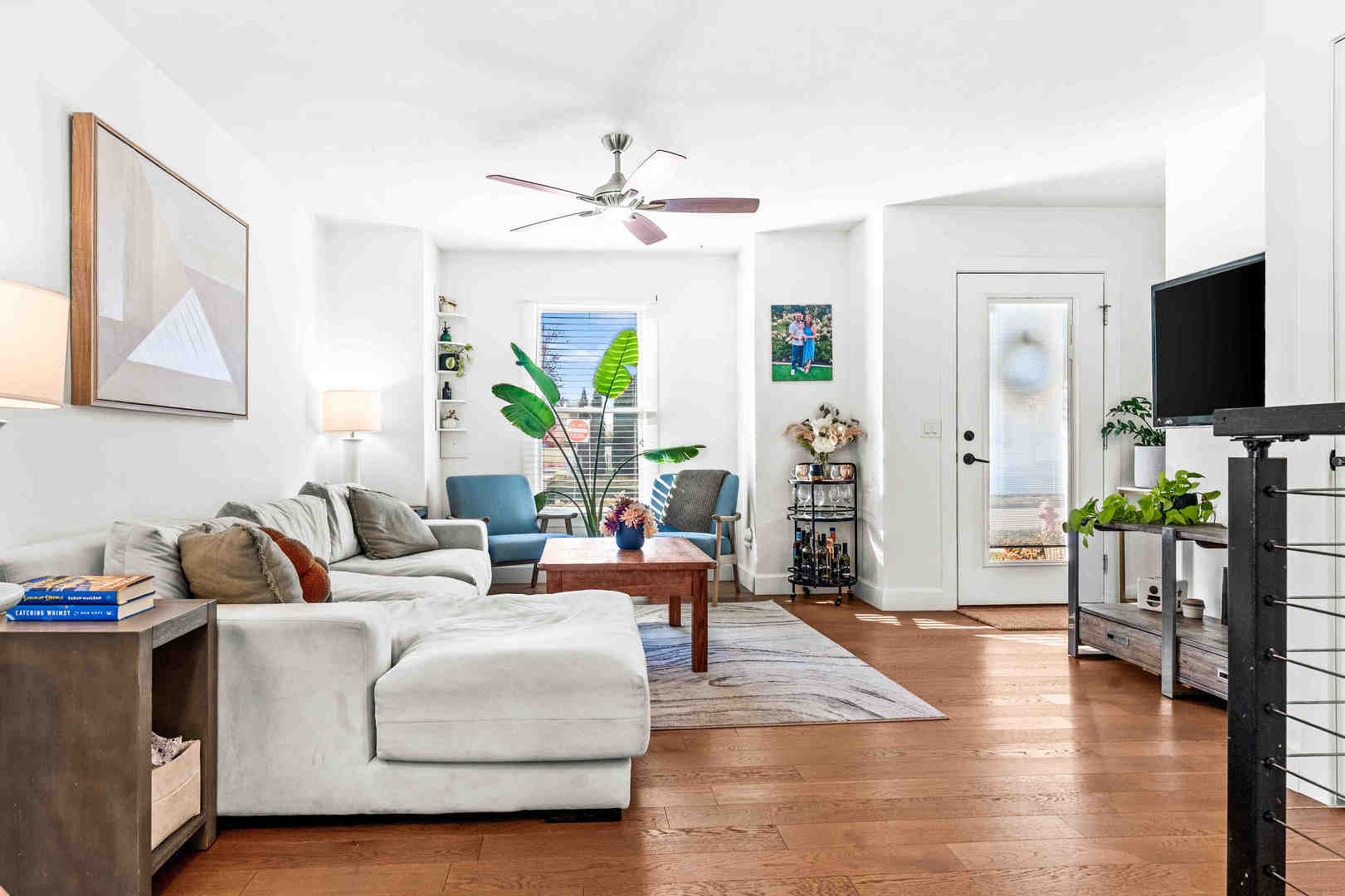 1402 River Landing Street Normal, IL 61761 - Photo 8 of 36 a living room with furniture a chandelier and a flat screen tv