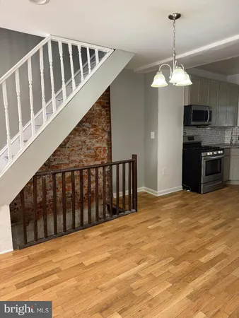 a view of staircase with railing and a chandelier