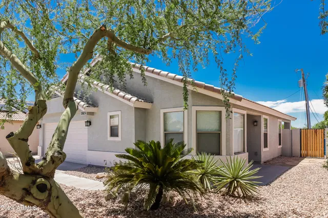 a view of a house with a tree