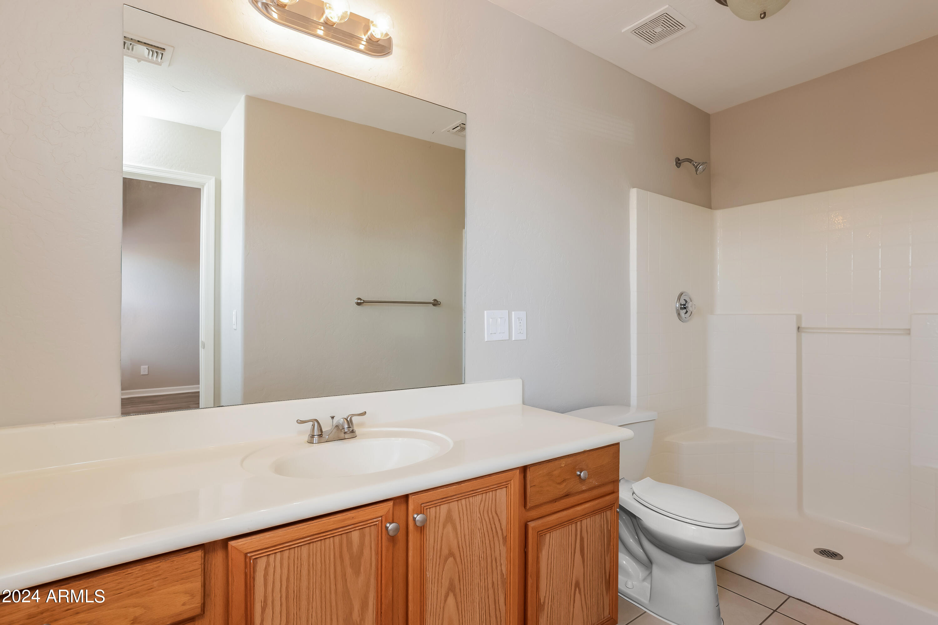 1815 East Hamel Way Phoenix, AZ 85022 - Photo 11 of 16 a bathroom with a sink toilet and shower
