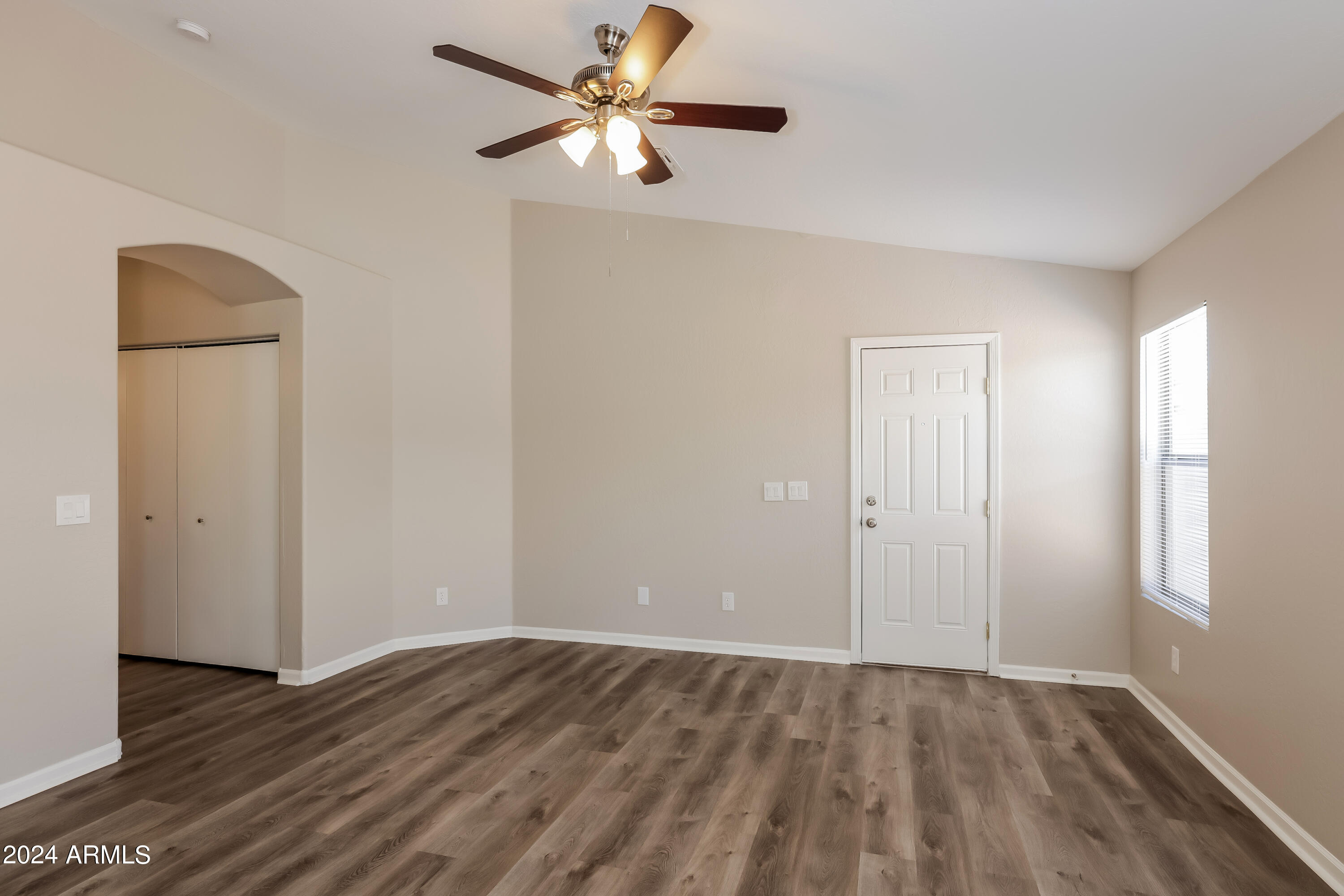 1815 East Hamel Way Phoenix, AZ 85022 - Photo 3 of 16 wooden floor in an empty room with a window