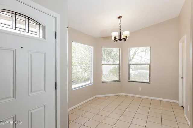 an empty room with windows and entrance