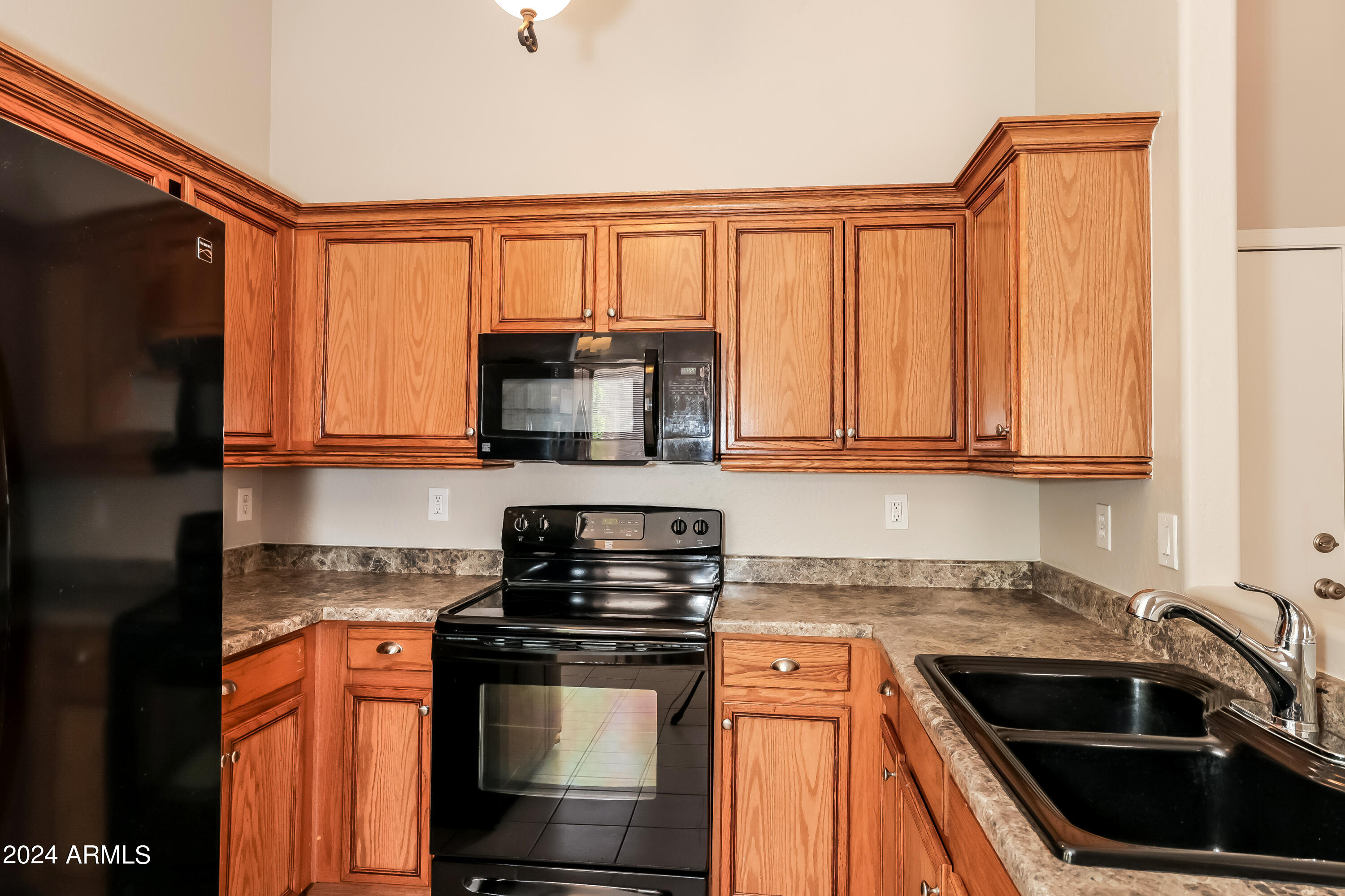 1815 East Hamel Way Phoenix, AZ 85022 - Photo 7 of 16 a kitchen with stainless steel appliances granite countertop a stove microwave and sink