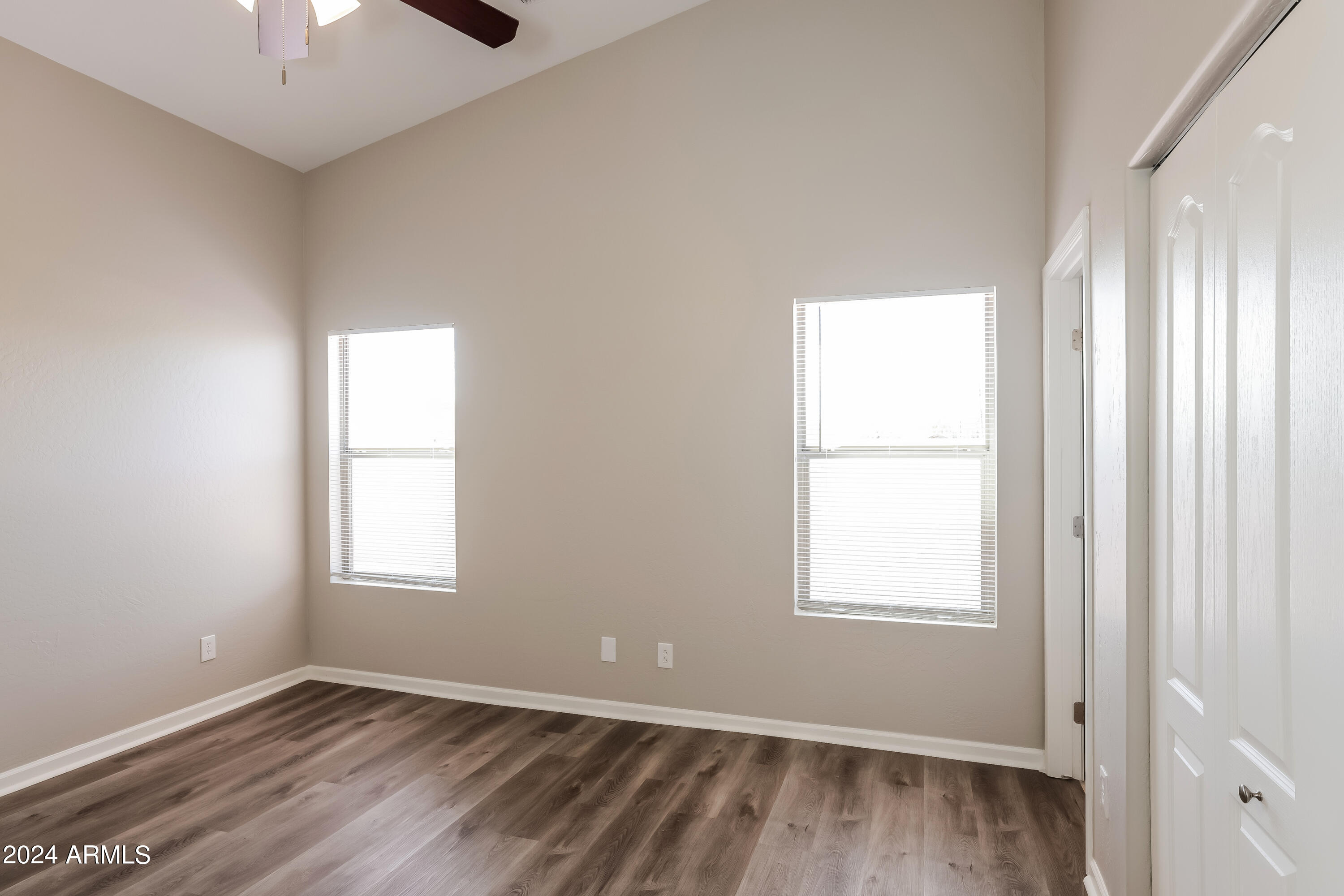 1815 East Hamel Way Phoenix, AZ 85022 - Photo 10 of 16 an empty room with windows and chandelier fan