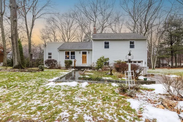 a view of a house with a yard covered with snow