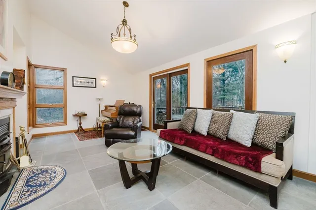 a living room with furniture and a floor to ceiling window
