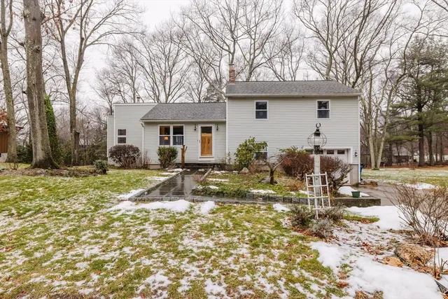 a view of a house with a yard covered in snow
