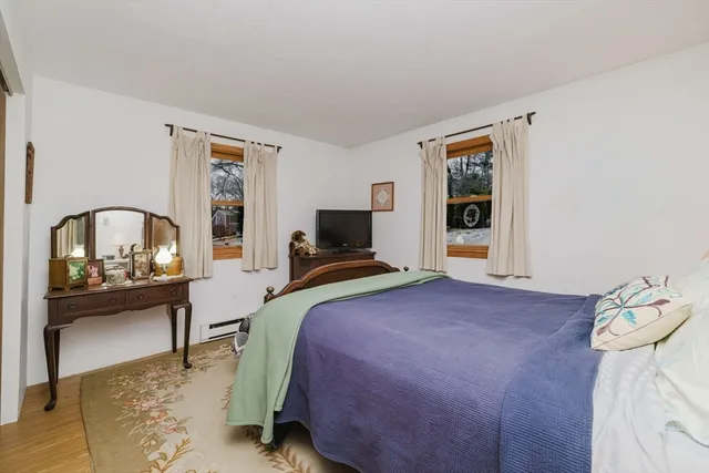 a view of dining room with wooden floor and furniture