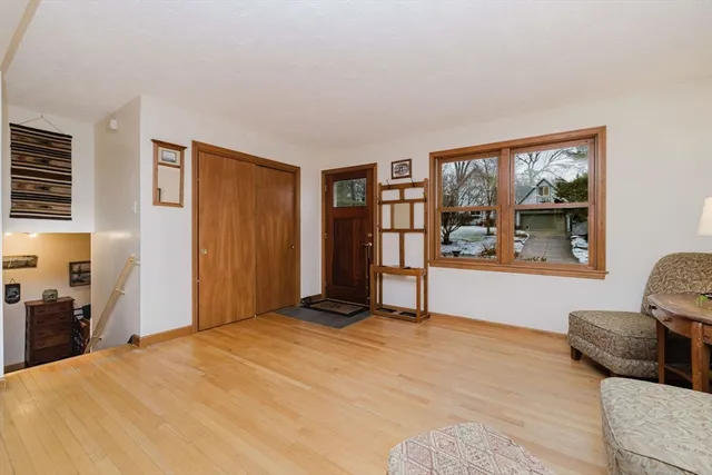 a kitchen with stainless steel appliances granite countertop wooden cabinets a sink a stove a dining table and chairs