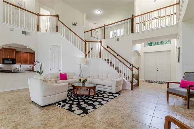 a living room with a stairs and white walls