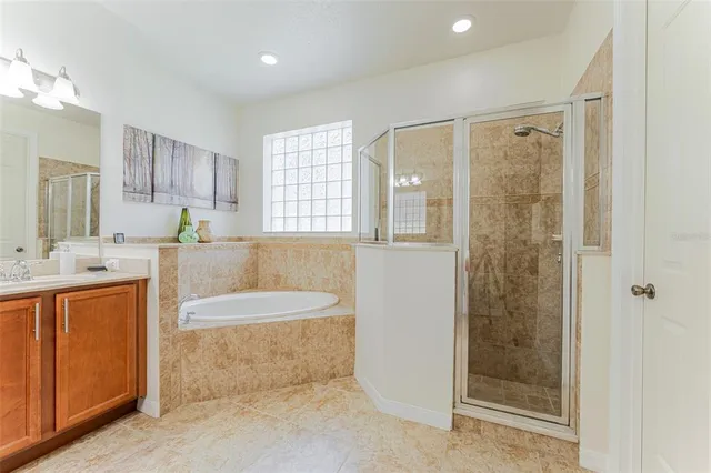 a bathroom with a tub sink and mirror