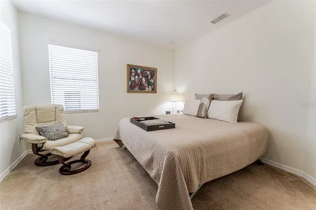 a bedroom with a bed and a couch