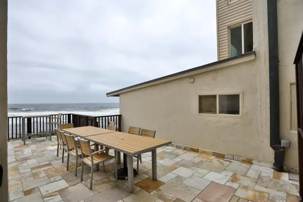 a view of a roof deck with table and chairs