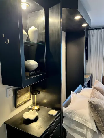 a bedroom with two beds and a flat screen tv