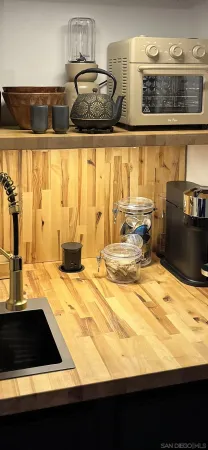 a living room with furniture and kitchen