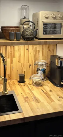 a living room with furniture and kitchen