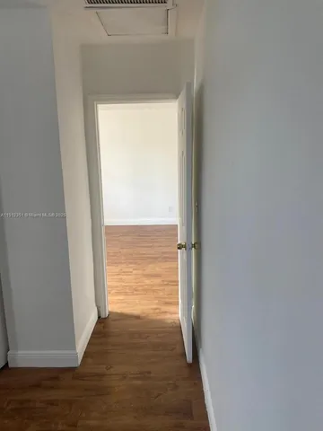 a view of an empty room and wooden floor