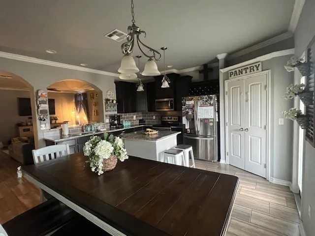 a living room with furniture a flat screen tv and a floor to ceiling window