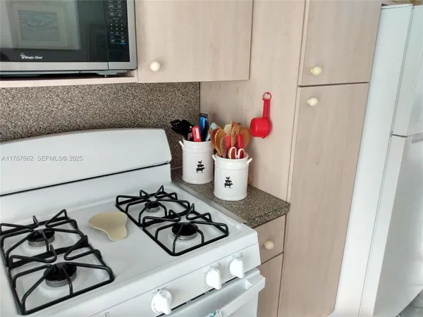 a kitchen with a stove and a refrigerator