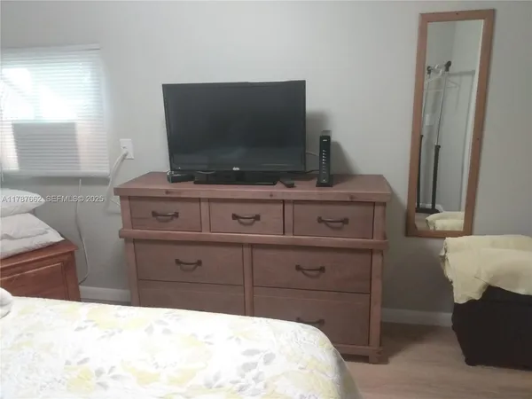 a room with a bed and a television