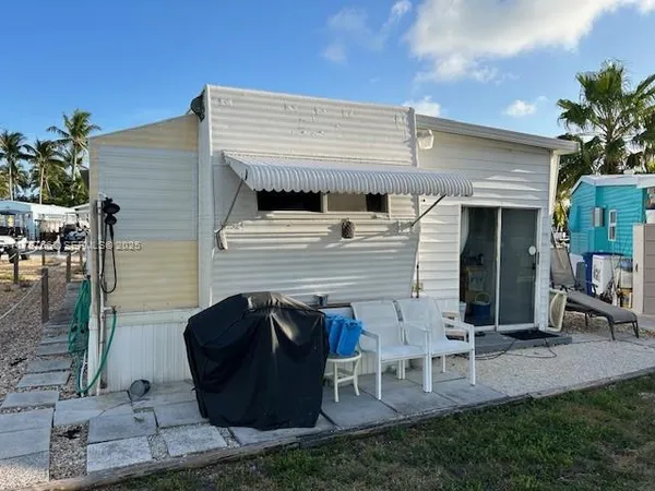 a view of a two chairs in front of house
