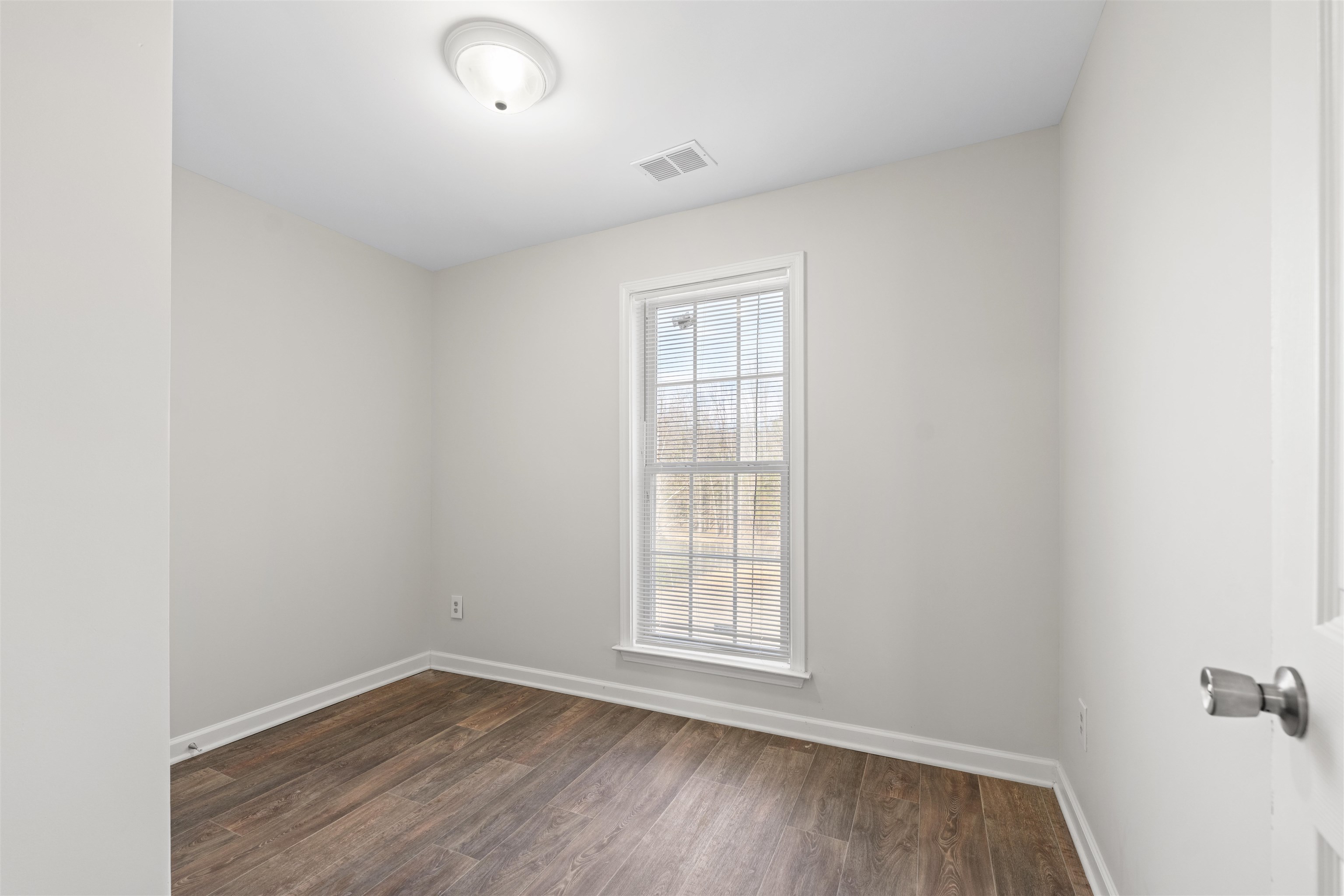 465 Metro Road Eads, TN 38028 - Photo 12 of 27 an empty room with wooden floor and windows