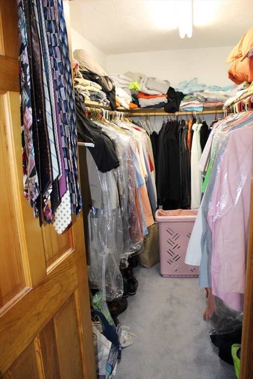 27 Gretchen Way Raynham, MA 02767 - Photo 12 of 20 a view of walk in closet with clothes and shoes