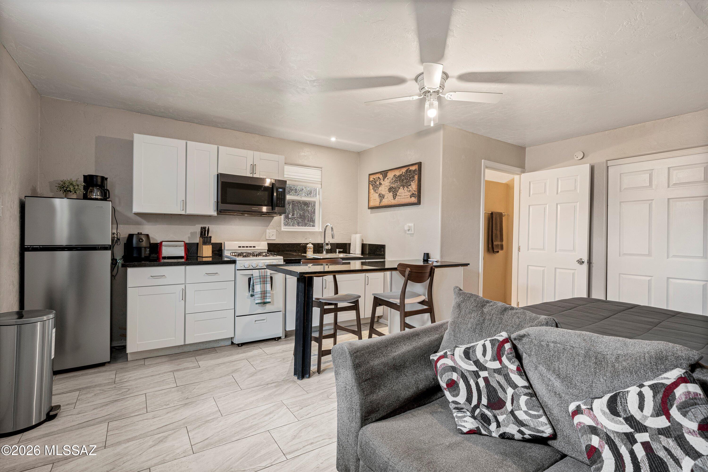 2841 North Richey Boulevard Tucson, AZ 85716 - Photo 27 of 30 a kitchen with a sink appliances and cabinets
