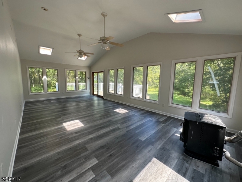 213 Sand Shore Road Budd Lake, NJ 07828 - Photo 14 of 26 a view of an empty room with wooden floor and a window