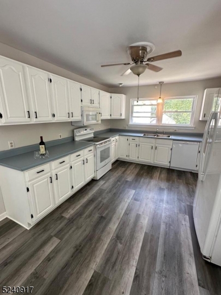 213 Sand Shore Road Budd Lake, NJ 07828 - Photo 6 of 26 a kitchen with granite countertop a stove a sink and white cabinets with wooden floor