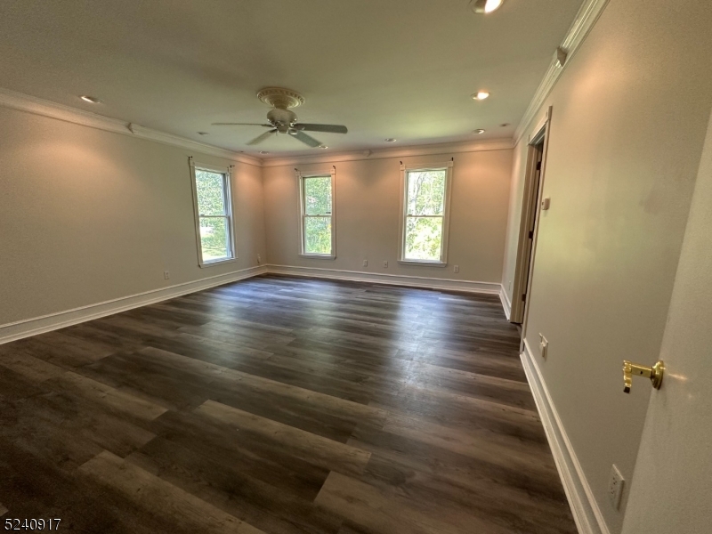 213 Sand Shore Road Budd Lake, NJ 07828 - Photo 8 of 26 an empty room with wooden floor and windows