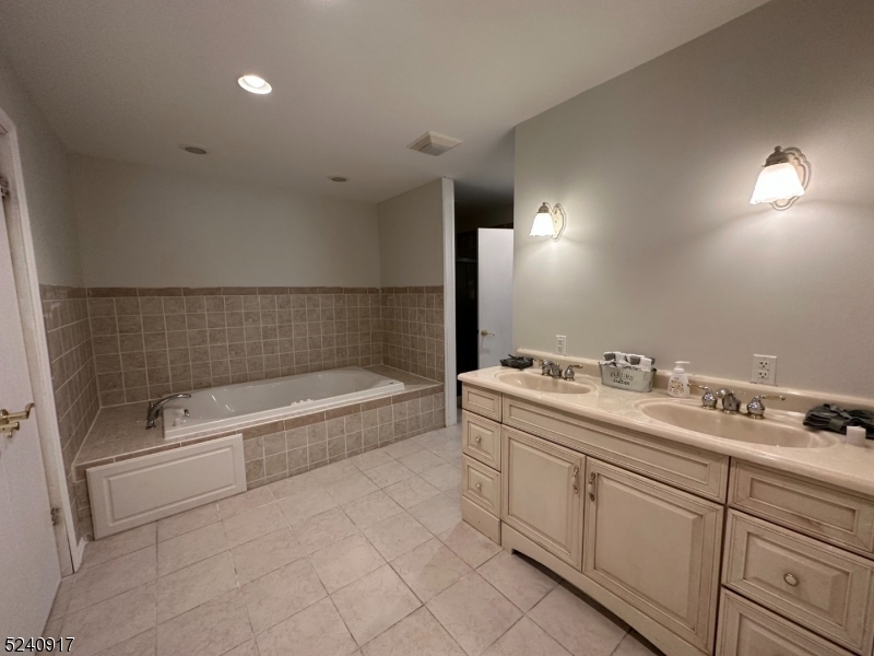 213 Sand Shore Road Budd Lake, NJ 07828 - Photo 10 of 26 a bathroom with a bathtub and a sink