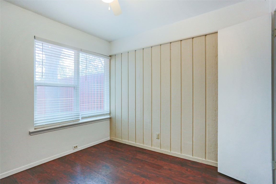 1003 Beaver Trail, Unit A Austin, TX 78746 - Photo 12 of 15 a view of an empty room with wooden floor and a window