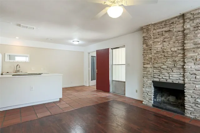 a view of a livingroom with an empty space and a fireplace