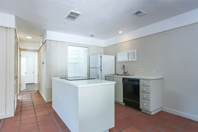 a kitchen with stainless steel appliances granite countertop a refrigerator a sink and a stove