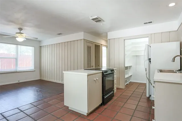 a kitchen with a stove a sink and a refrigerator
